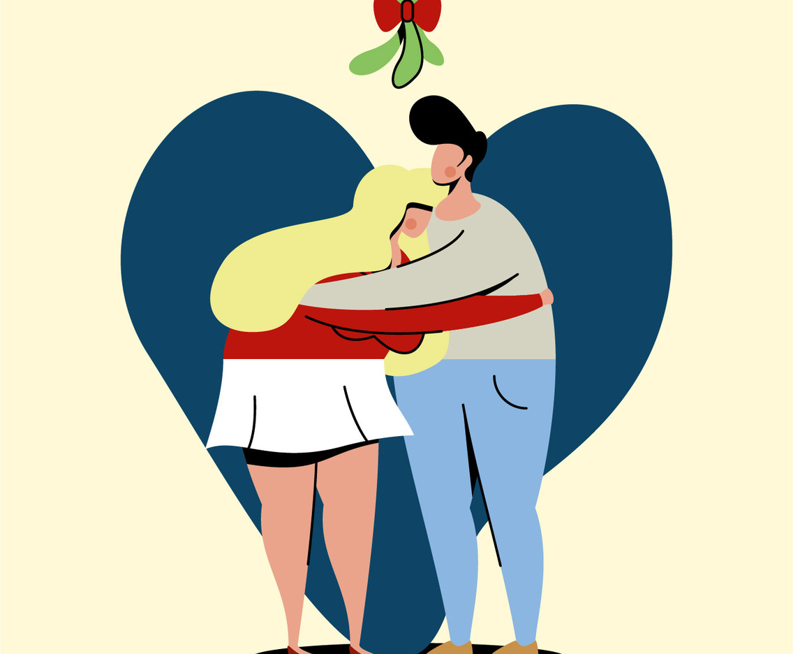 couple standing under mistletoe